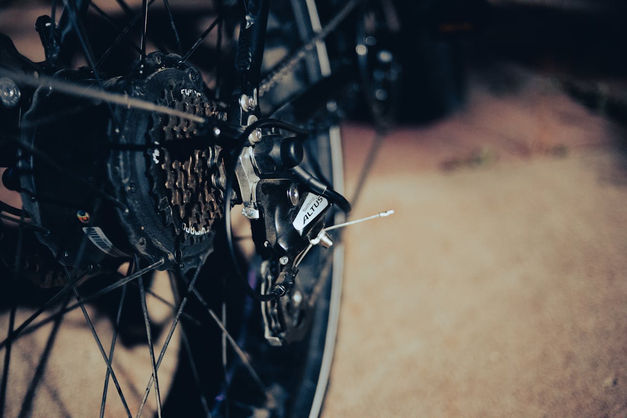 Detailed view of a bicycle rear derailleur and gears, emphasizing mechanical design.